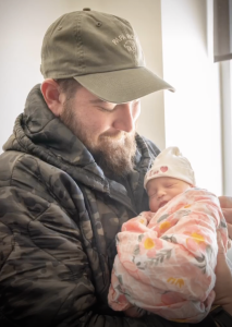 Man holding baby girl