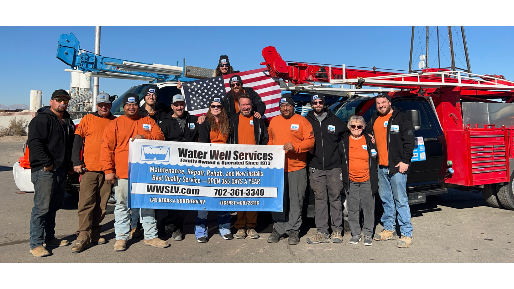 Water Well Services, Inc. team photo with red service truck in background.