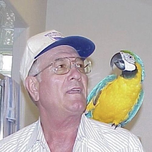 Mr. Steele with parrot on shoulder